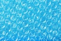 Packing bubble wrap for parcels on a blue background in full screen Royalty Free Stock Photo