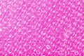 Packing bubble wrap for parcels on a Pink background in full screen Royalty Free Stock Photo