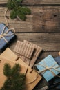 Packing christmas gifts in vintage beige blue roll paper on old wooden desk. Top View. Flat Lay. Copy space. Royalty Free Stock Photo