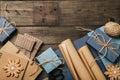 Packing christmas gifts in vintage beige blue roll paper on old wooden desk. Top View. Flat Lay. Copy space. Royalty Free Stock Photo