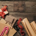 Packing Christmas gifts in vintage beige blue roll paper on old wooden desk. Top View. Flat Lay. Copy space. Royalty Free Stock Photo