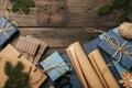 Packing christmas gifts in vintage beige blue roll paper on old wooden desk. Top view. Flat lay. Copy space. Royalty Free Stock Photo