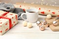 Packing Christmas presents with cup hot tea Royalty Free Stock Photo