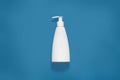 Packing with liquid soap isoaltedover blue studio background, cosmetic white empty plastic bottle with clipping path, front view Royalty Free Stock Photo