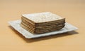 Packing matzo for Pesach square shape lies on a plate on the table