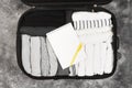 Packing of monochrome clothes in black suitcase. Packing list in Royalty Free Stock Photo