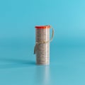 Packing a plumbers linen thread seal on a blue background. Minimal concept