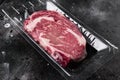 Packing raw beef steak in vacuum, on black dark stone table background, with copy space for text Royalty Free Stock Photo