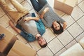 Packing sorted. Now to rest. a happy young couple relaxing on the floor of their new home. Royalty Free Stock Photo