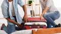 Packing suitcase. Couple trying to close valise Royalty Free Stock Photo