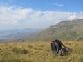 Backpack on the ground with behind the mountains in Albania. Royalty Free Stock Photo