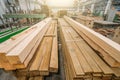 Packs of different wooden beams in woodworking workshop close up