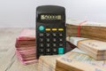 Packs of hryvnia and a calculator. Financial concept. Ukrainian banknotes. 500 and 200 hryvnias. 50,000 on the calculator display.