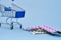 packs of pills in a trolley shopping in a pharmacy medicines