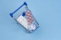 packs of pills in a trolley shopping in a pharmacy medicines