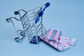 packs of pills in a trolley shopping in a pharmacy medicines