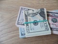 Packs of real dollar banknotes on a wooden table. Thousands dollars of cash.