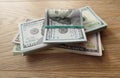 Packs of real dollar banknotes on a wooden table. Thousands dollars of cash.