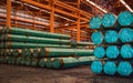 Packs of steel tube stack in layers inside storage area of large distribution warehouse.