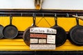 Old Cast Iron Pans With A Kitchen Rules Sign on the Side of a School Bus