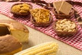 Pacoca, Pe de Moleque, Peanut, Cookie, Cake, Corn: food of Festa Junina, a typical brazilian party. On red and white plaid patter