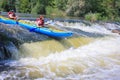 Pacuare River, Costa Rica - March 14 2019: Young couple enjoy white water kayaking on the river