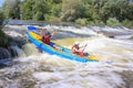 Pacuare River, Costa Rica - March 14 2019: Young couple enjoy white water kayaking on the river