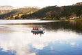 pacucha lake with boat with tourists sailing on a summer day in andahuaylas peru