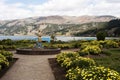 pacucha lake with mountains and a sculpture of a mermaid