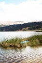 pacucha lake with wooden boat anchored in reed plantation splendid on a summer day in andahuaylas peru Royalty Free Stock Photo