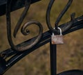 Pad lock on a metal black fence. Padlock that has rusted. Royalty Free Stock Photo