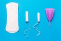 Pad, menstrual cup, tampon on a blue background. Royalty Free Stock Photo