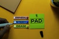 PAD. Peripheral Artery Disease acronym on sticky notes. Office desk background