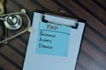 PAD - Peripheral Artery Disease write on sticky notes isolated on Wooden Table