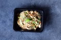 Pad thai chicken with vegetable udon noodles in dark background, top view. Asian-style vegetarian food. Royalty Free Stock Photo