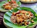 Pad Thai, the famous Thai food menu noodle stir-fried cook with egg, pork, long bean and peanut, put on banana leaf plate.