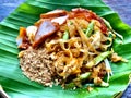 Pad Thai, the famous Thai food menu noodle stir-fried cook with egg, pork, long bean and peanut, put on banana leaf plate.