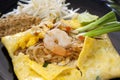 Pad Thai, fried noodles with shrimps in Omelet