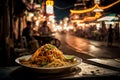 Pad Thai, a mouthwatering dish of fried noodles in a busy Thai night market