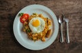 Pad Thai noodles with Omelette and tomato on wooden table