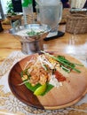 Pad thai soup ingridients fried noodles stier lime pepper chilli spouse cooker wood plate chiang mai thai food cooking