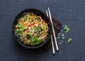 Pad Thai vegetarian vegetables udon noodles in a dark background, top view. Vegetarian food in asian style. Royalty Free Stock Photo