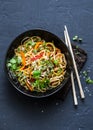 Pad Thai vegetarian vegetables udon noodles in a dark background, top view. Vegetarian food in asian style. Royalty Free Stock Photo