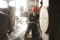 Zinc mine. Engineer cleaning machine in factory.