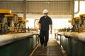 Zinc mine. Engineer walking to check machinery in factory.