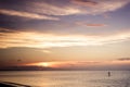 Paddle boarder in bay at sunset Royalty Free Stock Photo