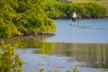 A paddle boarder in Florida on a inland waterway at low tide