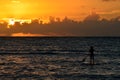 A paddle boarder goes out to greet the sunrise Royalty Free Stock Photo