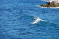 Standup paddle boarder surfing off Heisler Park, Laguna Beach, California.