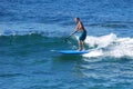 Paddle boarder surfing at St. Anns Beach in Laguna Beach, California.